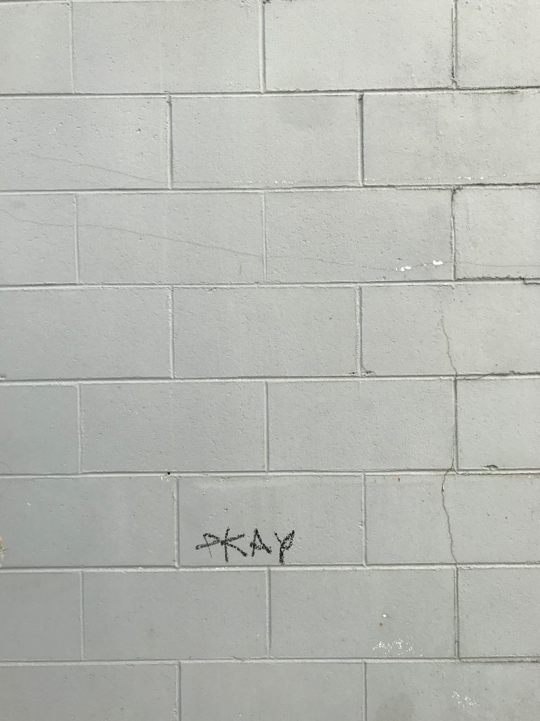 A PKAY tag on a large wall in central Christchurch.