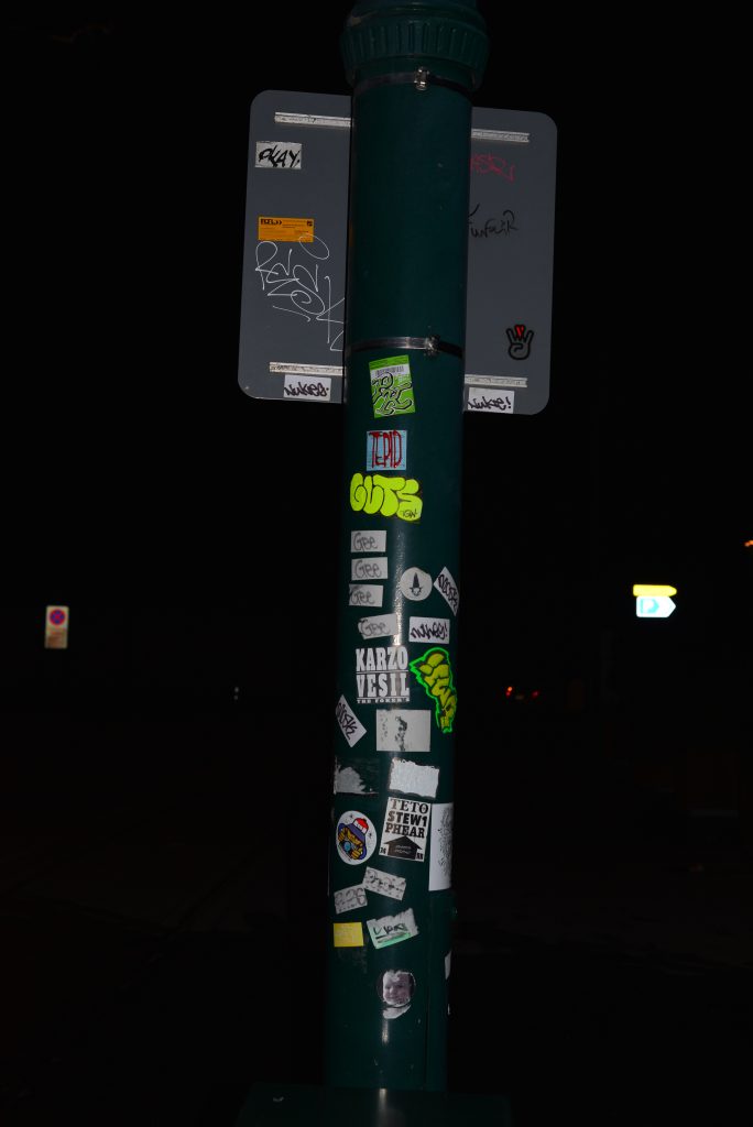 Stickers adorning a street sign in Cathedral Junction. (Photo Credit: Aaron P.K.)