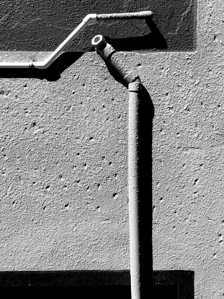 A black and white photograph of plastic piping