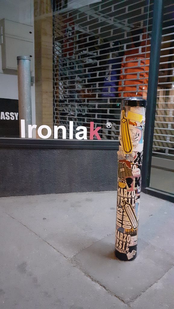 Stickers on a post outside a store in Christchurch