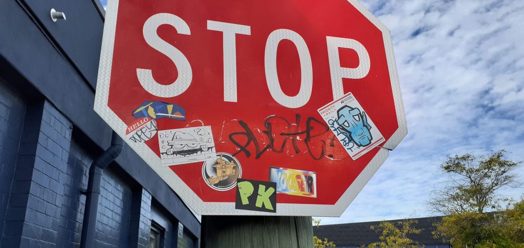 Stickers on a STOP sign in Christchurch