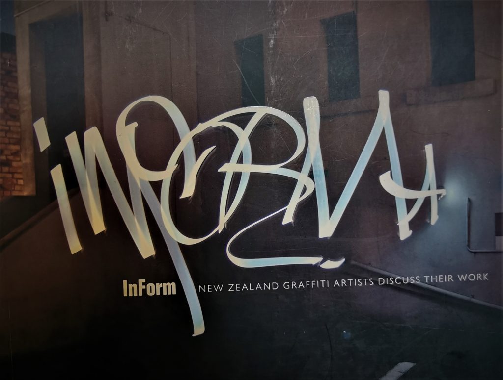 The cover of InForm, with the title written in light in an urban environment