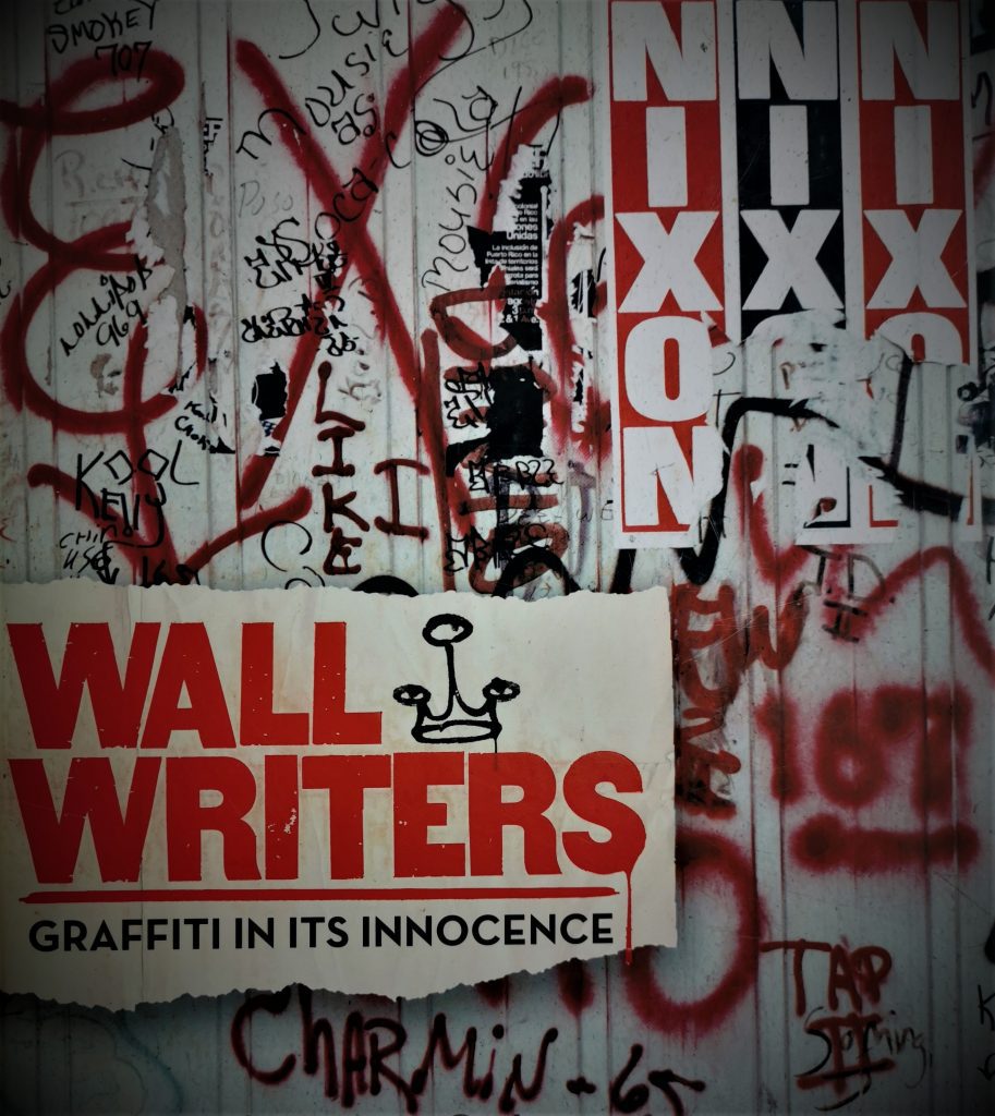 The cover of the book Wall Writers, featuring a 1970s wall heavy with graffiti and posters