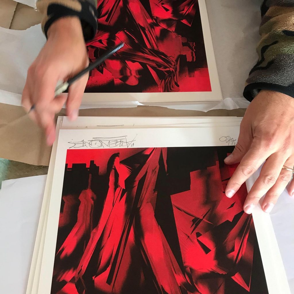 Askew One signs his MK Press x Fiksate collab risograph prints. (Photo credit: Elliot O'Donnell)