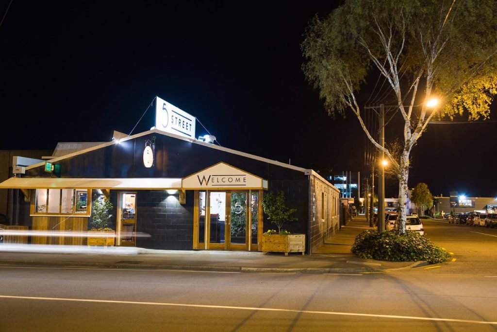 The restaurant 5th Street is photographed at night from outside.