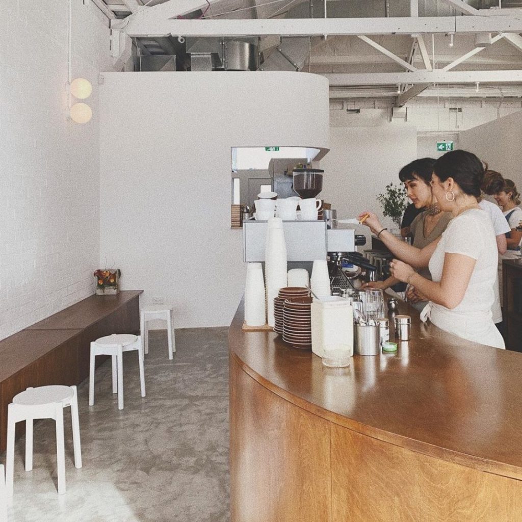 Some barista's prepare coffee inside the Child Sister cafe